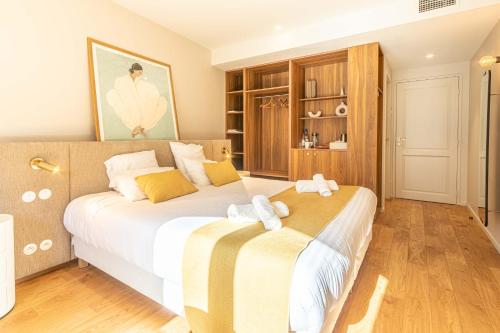 a bedroom with a large bed with towels on it at La Maison De Blanche in Bordeaux