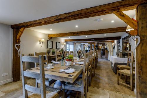 a dining room with a wooden table and chairs at The Grousemoor - North Wales luxury 7 bedroom holiday rental in Llandegla