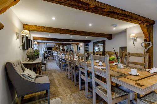a dining room with a long table and chairs at The Grousemoor - North Wales luxury 7 bedroom holiday rental in Llandegla