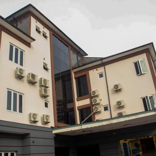 a building with air conditioners on the side of it at Merzino Palace in Uyo