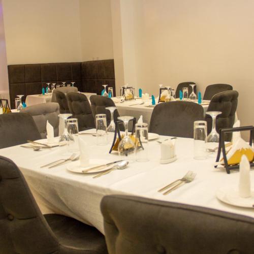 a group of tables and chairs in a room at Merzino Palace in Uyo