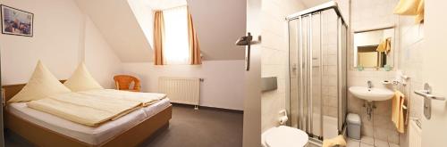 a bedroom with a bed and a bathroom with a sink at Hotel zum Alten Wirt in Langenbach