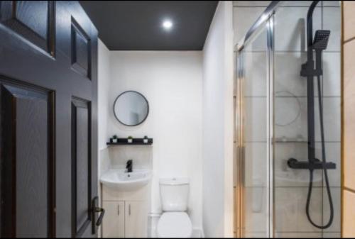 a bathroom with a shower and a toilet and a sink at The Residency rooms Liverpool in Wallasey