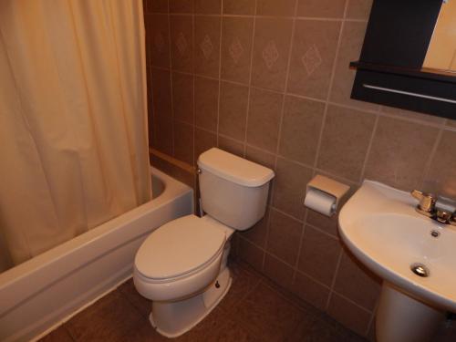 a bathroom with a toilet and a sink at Nox Hostel in Toronto