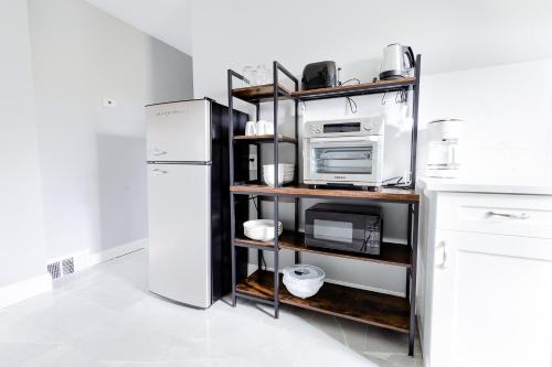 a kitchen with a microwave and a refrigerator at Comfy Micro Apartment 1BR 1 Bath close to the falls in Niagara Falls