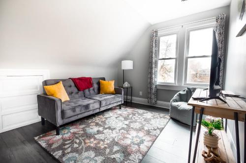 a living room with a couch and a television at Comfy Micro Apartment 1BR 1 Bath close to the falls in Niagara Falls