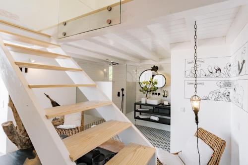 a room with a spiral staircase in a house at Conversas de Alpendre in Vila Nova de Cacela
