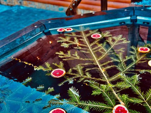 a christmas tree in a boat with ornaments on it at Guest House Pid Dubom Карпати Під Дубом in Skole