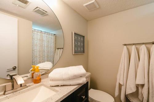 a bathroom with a sink and a mirror at GRAND STRAND FUN WITH SO MUCH TO DO - EVEN PICKLEBALL! in Myrtle Beach