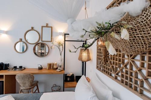 a bedroom with a bed and a desk and mirror at Conversas de Alpendre in Vila Nova de Cacela