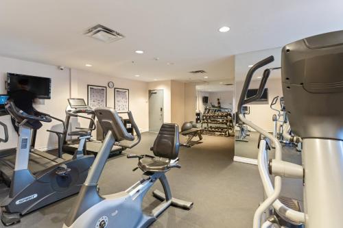 a gym with treadmills and exercise bikes in a room at Executive Hotel Vancouver Airport in Richmond