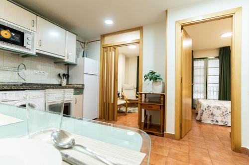 a kitchen with white appliances and a dining room at CAMBARAL 1E in Luarca