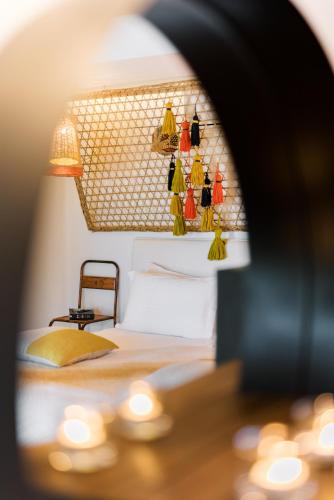 a bedroom with a bed and a table with lights at Conversas de Alpendre in Vila Nova de Cacela