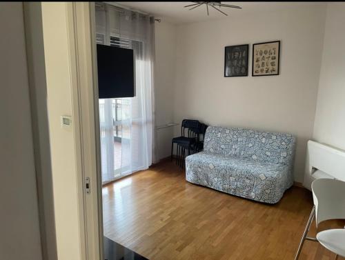a living room with a couch and a television at La casa di LUCA in Imola
