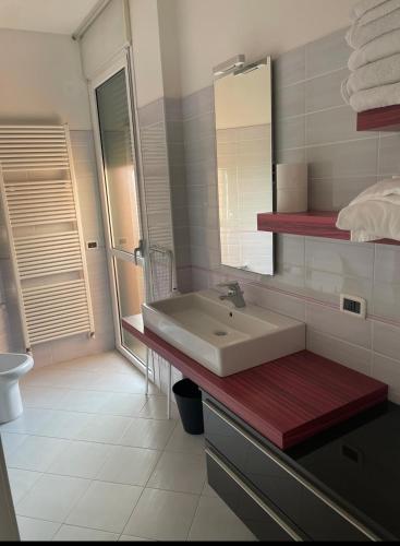 a bathroom with a sink and a mirror at La casa di LUCA in Imola