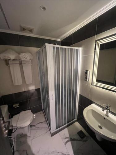 a bathroom with a shower and a sink at WOW Pyramids Inn With Rooftop Lounge in Cairo