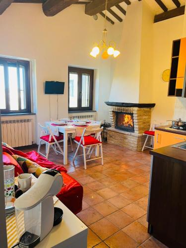 a living room with a table and a fireplace at Castelvecchio 172 in Sarnano