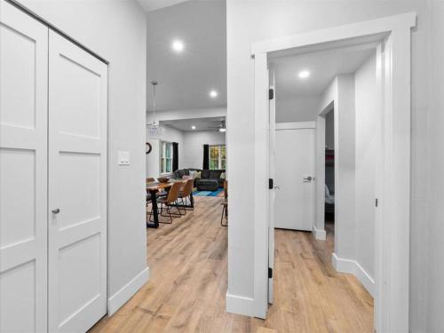 a hallway with white doors and a dining room at Bike House in Eagle