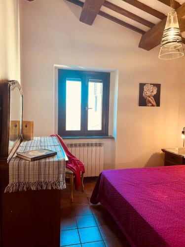 1 dormitorio con 2 camas y ventana en Castelvecchio 172, en Sarnano