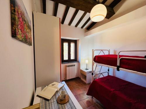 a small room with two bunk beds and a table at Castelvecchio 172 in Sarnano