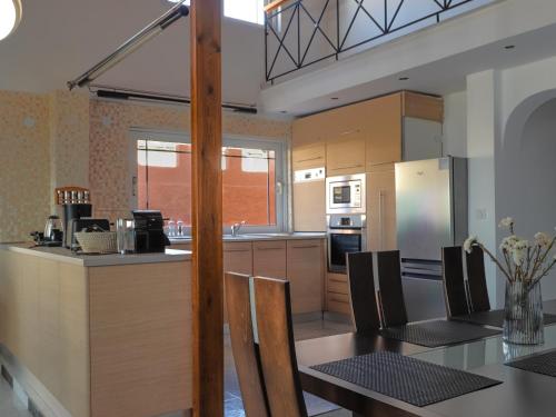 a kitchen with a table and a dining room at Angels beach house in Rhodes Town