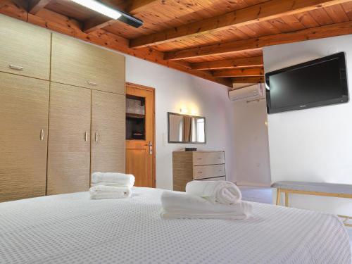 a bedroom with a white bed with towels on it at Angels beach house in Rhodes Town
