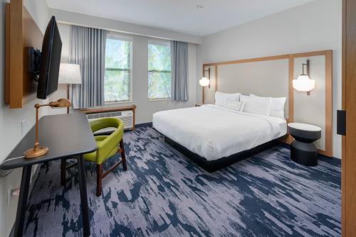 a hotel room with a bed and a desk and a television at Fairfield Inn & Suites Morganton Historic Downtown in Morganton