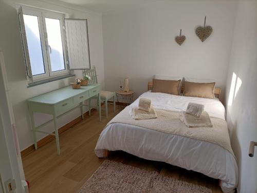 biała sypialnia z łóżkiem i biurkiem w obiekcie Inn Alentejo w mieście Castro Verde