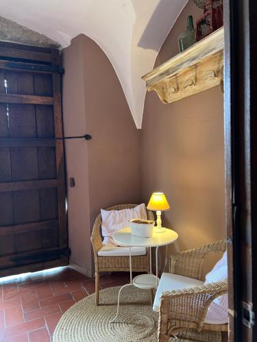 a room with a table and chairs and a door at Masia Quelet in La Vall de Bianya