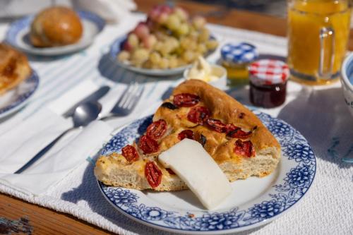 a slice of pizza on a blue and white plate at Monachofolitses in Kimolos
