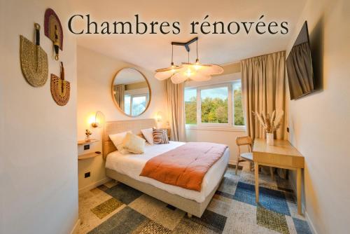 1 dormitorio con cama, escritorio y espejo en B Hôtel Olympia Bourges - Hotel Rénové avril 2024 en Bourges