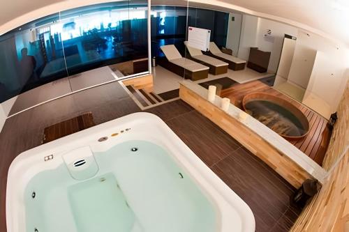 a bath tub in the middle of a room at Barra Bali: Resort Beira Mar in Barra de São Miguel