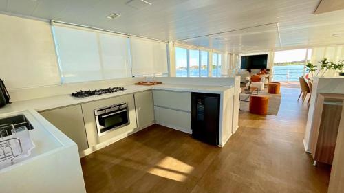 a kitchen with white counters and a stove top oven at WTS HOUSE BOAT in Brasilia