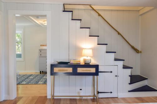a staircase in a home with a white and black stair case at 5 Min Drive to Fisher Beach and Pamet Harbor in Truro