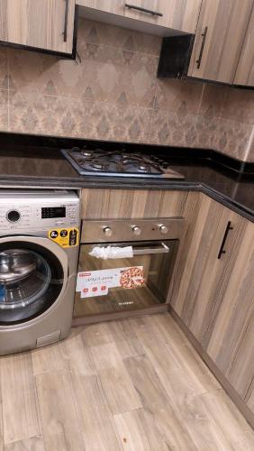 an open oven in a kitchen with a pizza inside at Rahma Hotel Shehap in Cairo