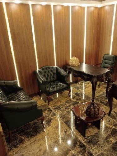 a room with a table and chairs and a piano at Rahma Hotel Shehap in Cairo