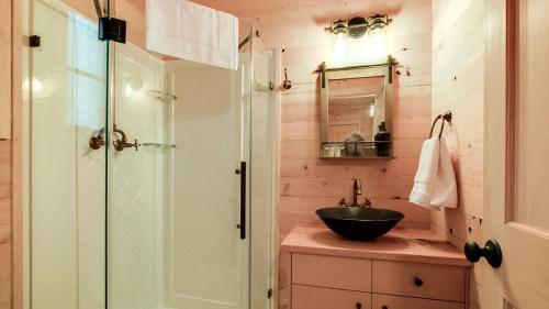 a bathroom with a sink and a shower at The Magnolia in Treehouse Grove at Norton Creek in Gatlinburg