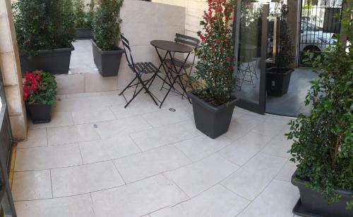 a patio with potted plants and a table and chairs at Da Nonno Ciccio in Valenzano