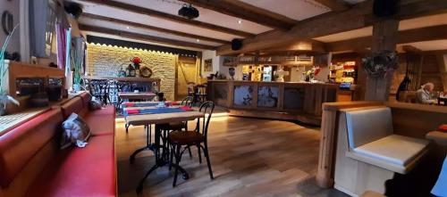 a restaurant with a bar and a table and chairs at Haus Wander-Lust in Lauterbach