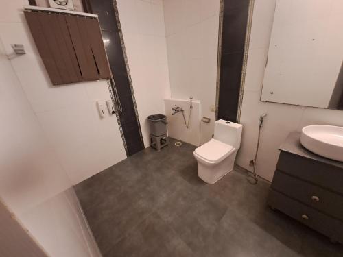 a bathroom with a toilet and a sink at Hotel Diamond Airport in New Delhi