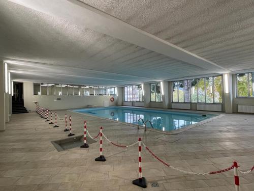 a large swimming pool in a large building at Accogliente Appartamento Prato Nevoso in Prato Nevoso
