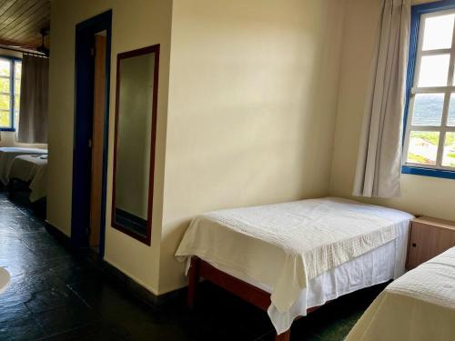 Una cama o camas en una habitación de Pousada Mucugê