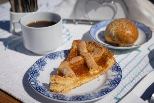 a plate with a piece of cake and a cup of coffee at Monachofolitses in Kimolos