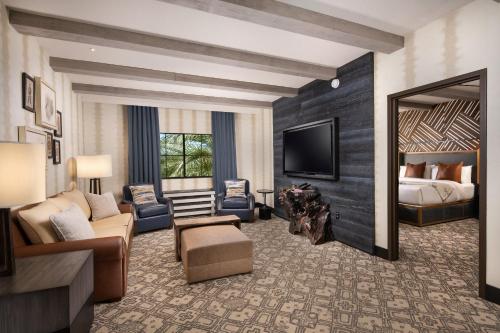 a hotel room with a bed and a living room at Silverton Casino Lodge - Newly Renovated in Las Vegas