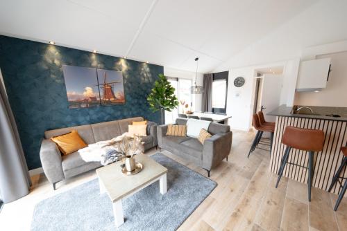 a living room with a couch and a table at Recreatiepark de Koornmolen in Zevenhuizen