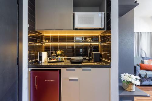a kitchen with a red refrigerator and a microwave at Flat 1111 WCT Berrini Brooklin in Sao Paulo