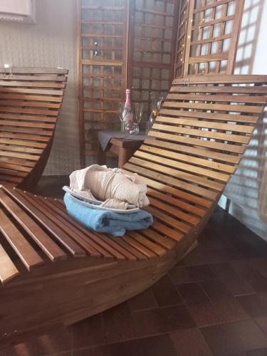 a wooden hammock with a blanket and a table at Hotel Untermetzger in Zell am Ziller