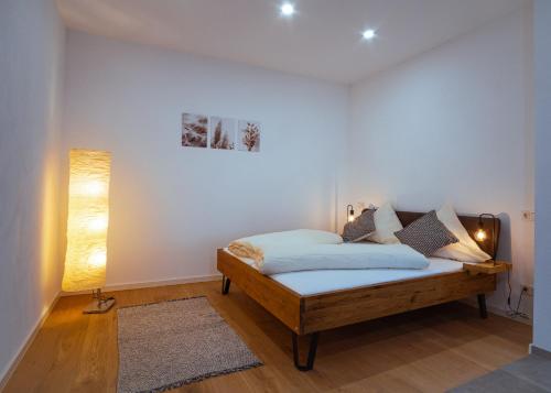 a bedroom with a bed in a room at Neue Loft im alten Kelterhaus - Urlaub im Wein- und Ferienort Bekond in Bekond