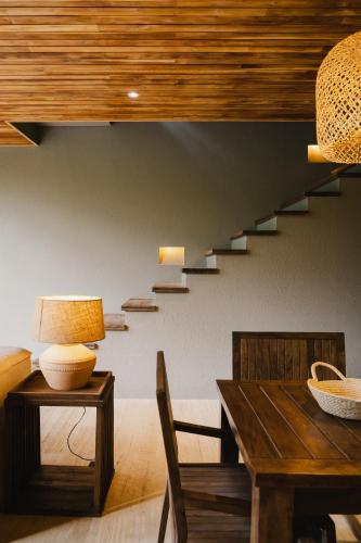 a dining room with a table and a staircase at Naio Hotel y Villas By OxoHotel in Palomino