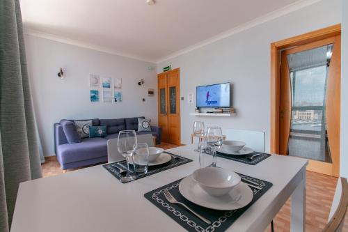 a kitchen and living room with a table with wine glasses at Grand Harbour View in Birgu